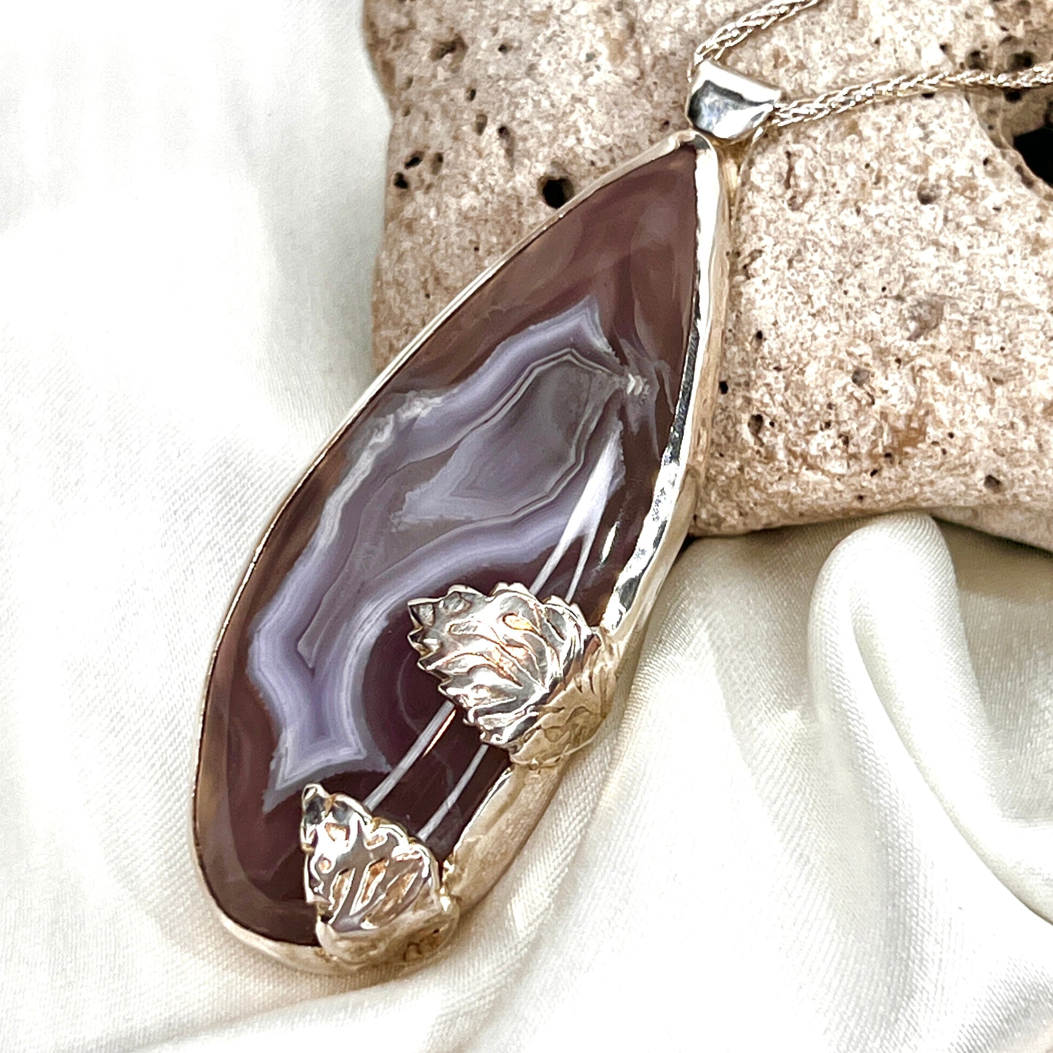 Purple agate pendant in sterling silver with two leaf accents on a white background with stone — DivineGemCat