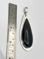 Size reference photo of handmade blue tiger eye sterling silver statement pendant next to ruler.
