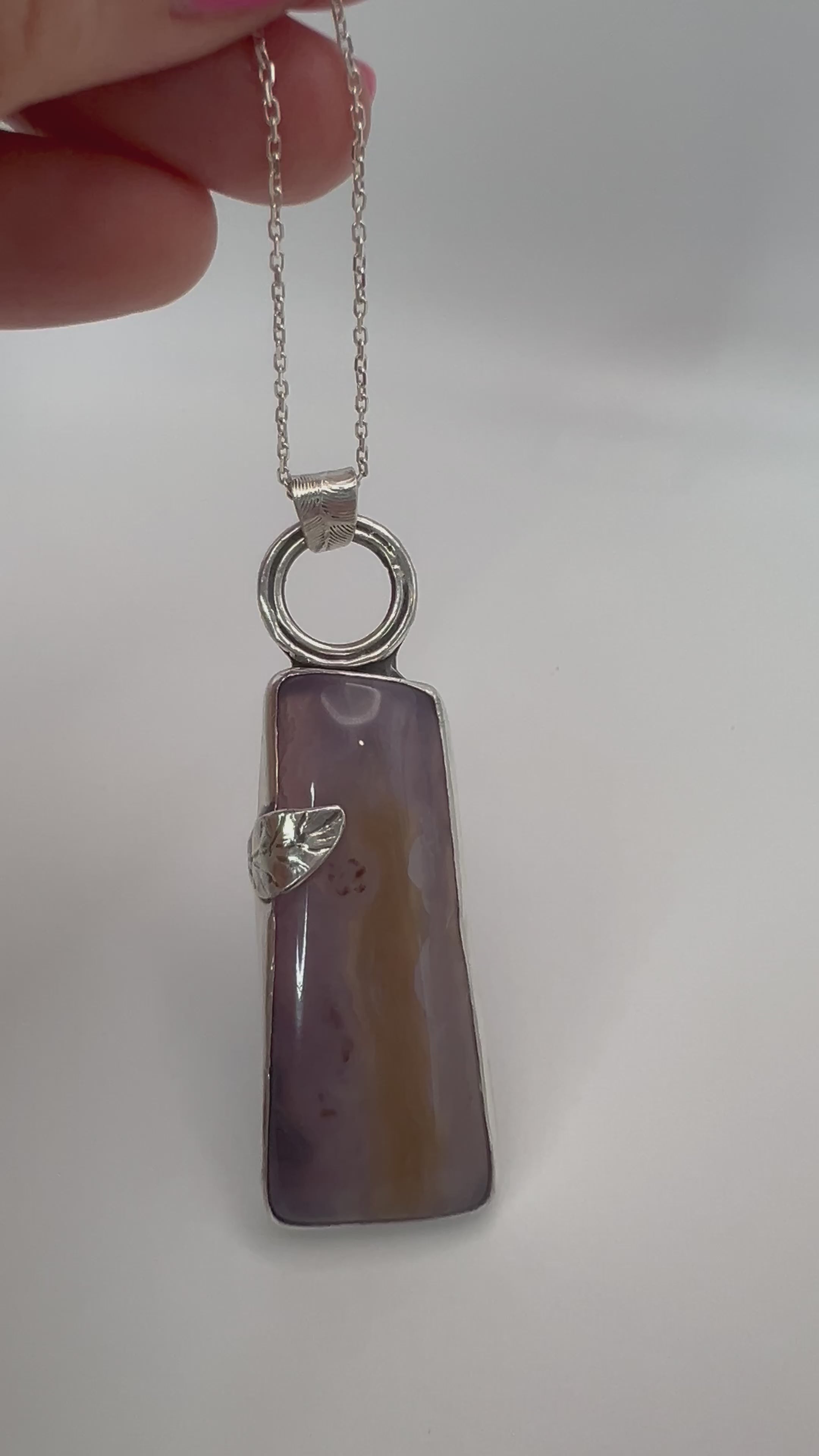 Live view of purple agate  in sterling silver pendant showing open-back design and leaf accent