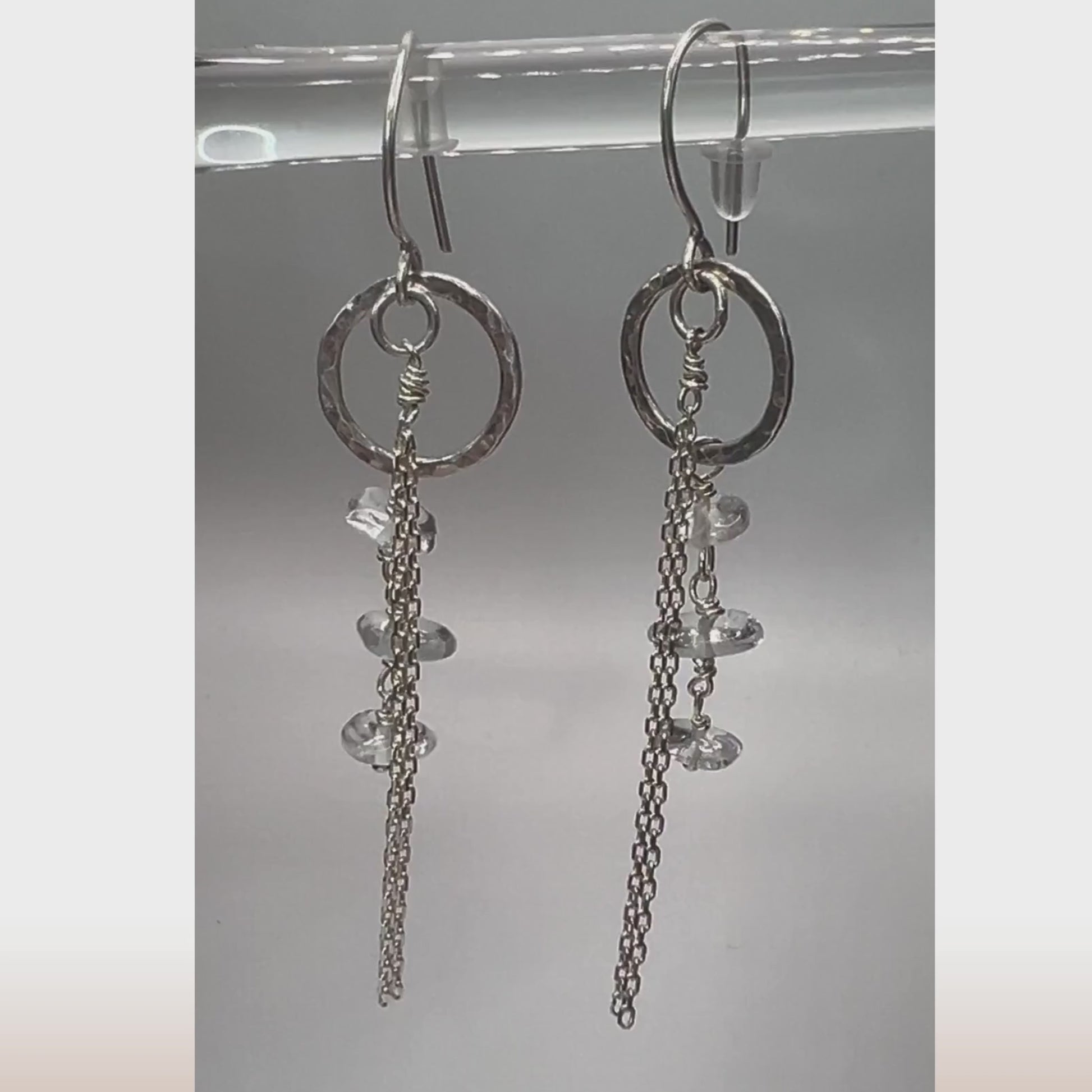 Live view of clear quartz drop earrings showing light-reflecting crystals and silver chain